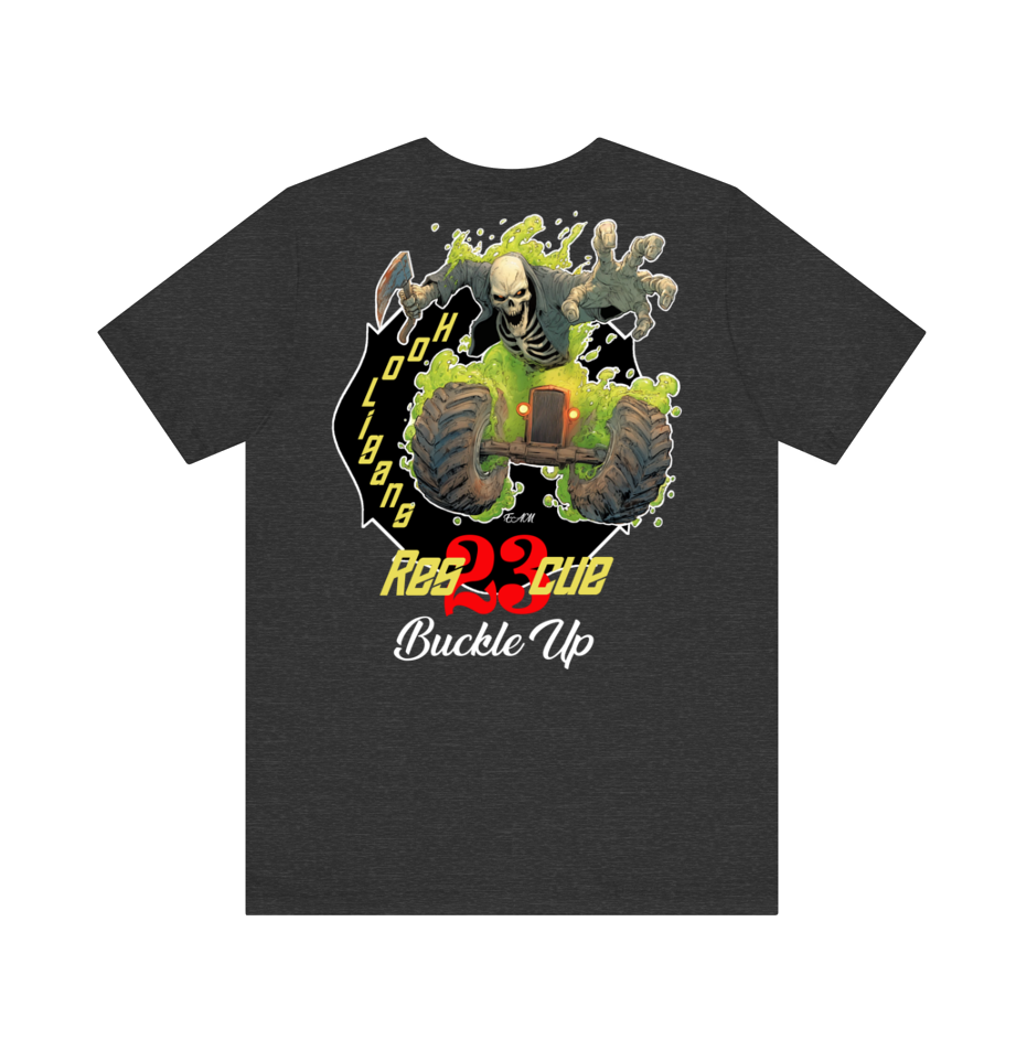 A dark heather gray t-shirt featuring a large graphic print on the front. The graphic depicts a skeleton riding a green buggy with a skull in its mouth, set against a black background with yellow and red text that reads 'REBELLION' and 'Buckle Up'.