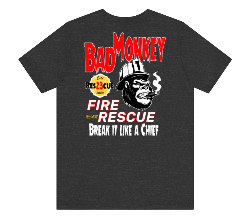 A dark heather gray t-shirt featuring a graphic print of a smoking gorilla wearing a firefighter helmet, with the text 'BAD MONKEY' in red, 'FIRE AND RESCUE' in red and white, and 'BREAK IT LIKE A CHIEF' in white.